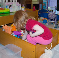 Julia sorting toys in the drawer