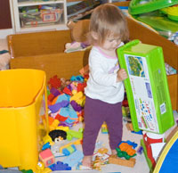 Sophia dumping out bins as I try to sort