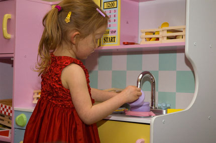 Julia with toy kitchen