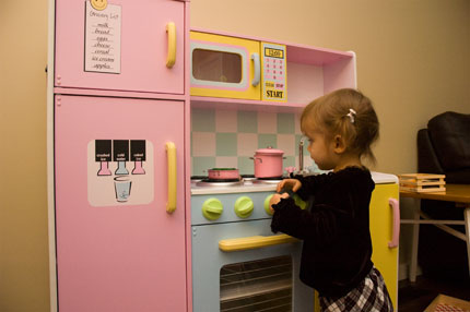 Sophia with toy kitchen