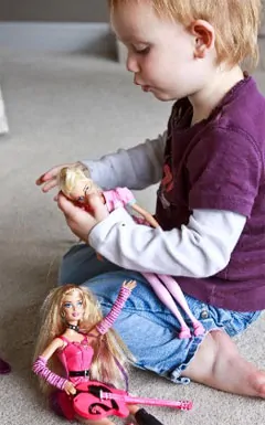 Little boy playing with barbie dolls 2025