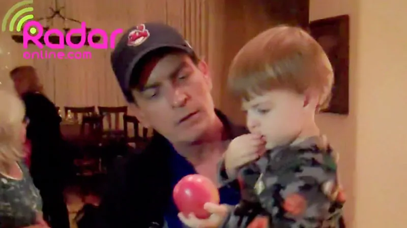 Charlie Sheen holds one of his 23-month-old twin