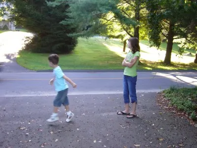 Big sister warned her little brother, "Don't go past that line when you're waiting for the bus."