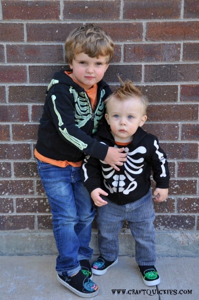 Preschooler and toddler wearing skeleton sweatshirts and glow in the dark monster shoes