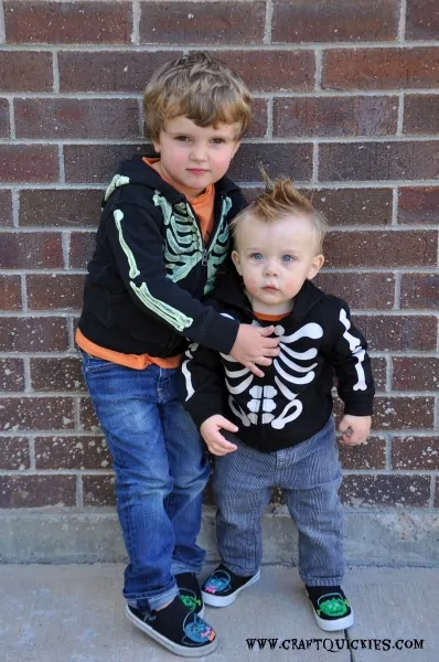 Preschooler and toddler wearing skeleton sweatshirts and glow in the dark monster shoes