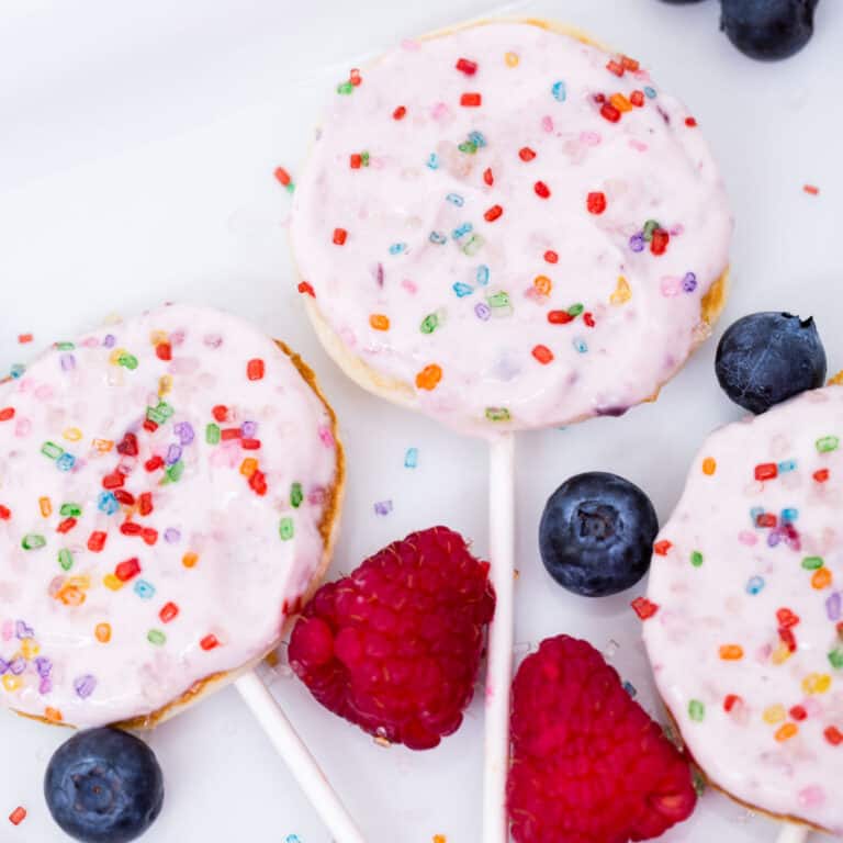 Lollipop pancakes with pink icing and sprinkles