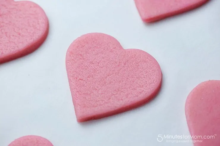 pink valentine sugar cookies on parchment paper
