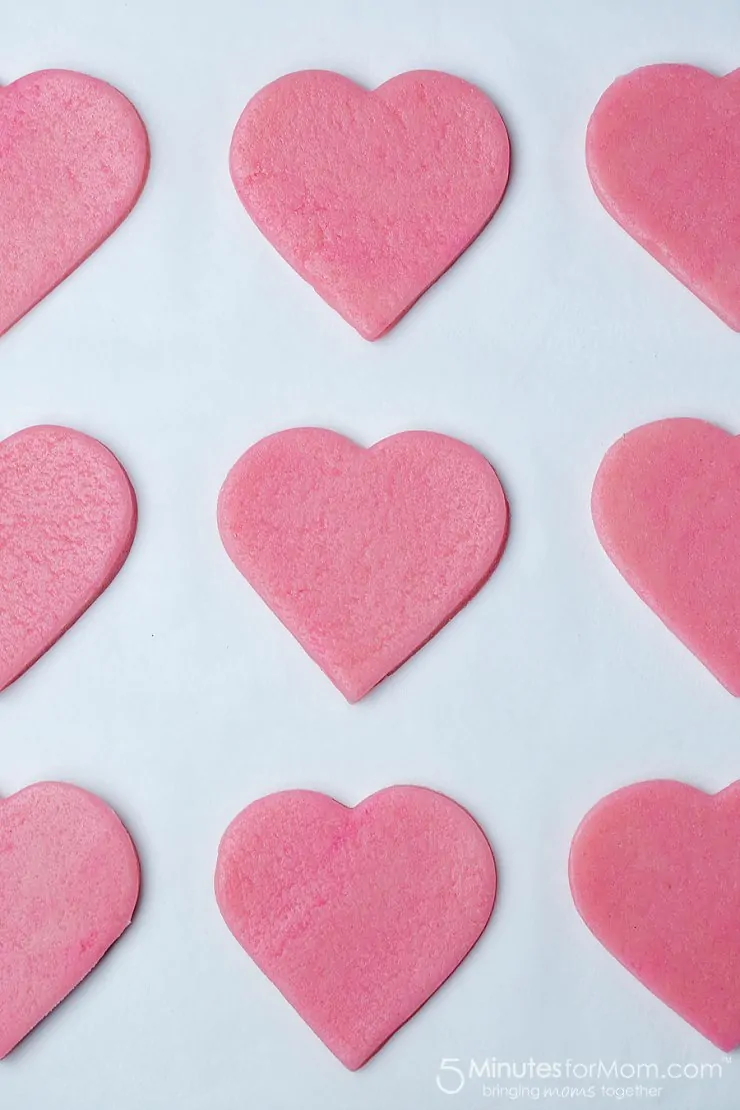 pink valentines cookies before baking on parchment paper