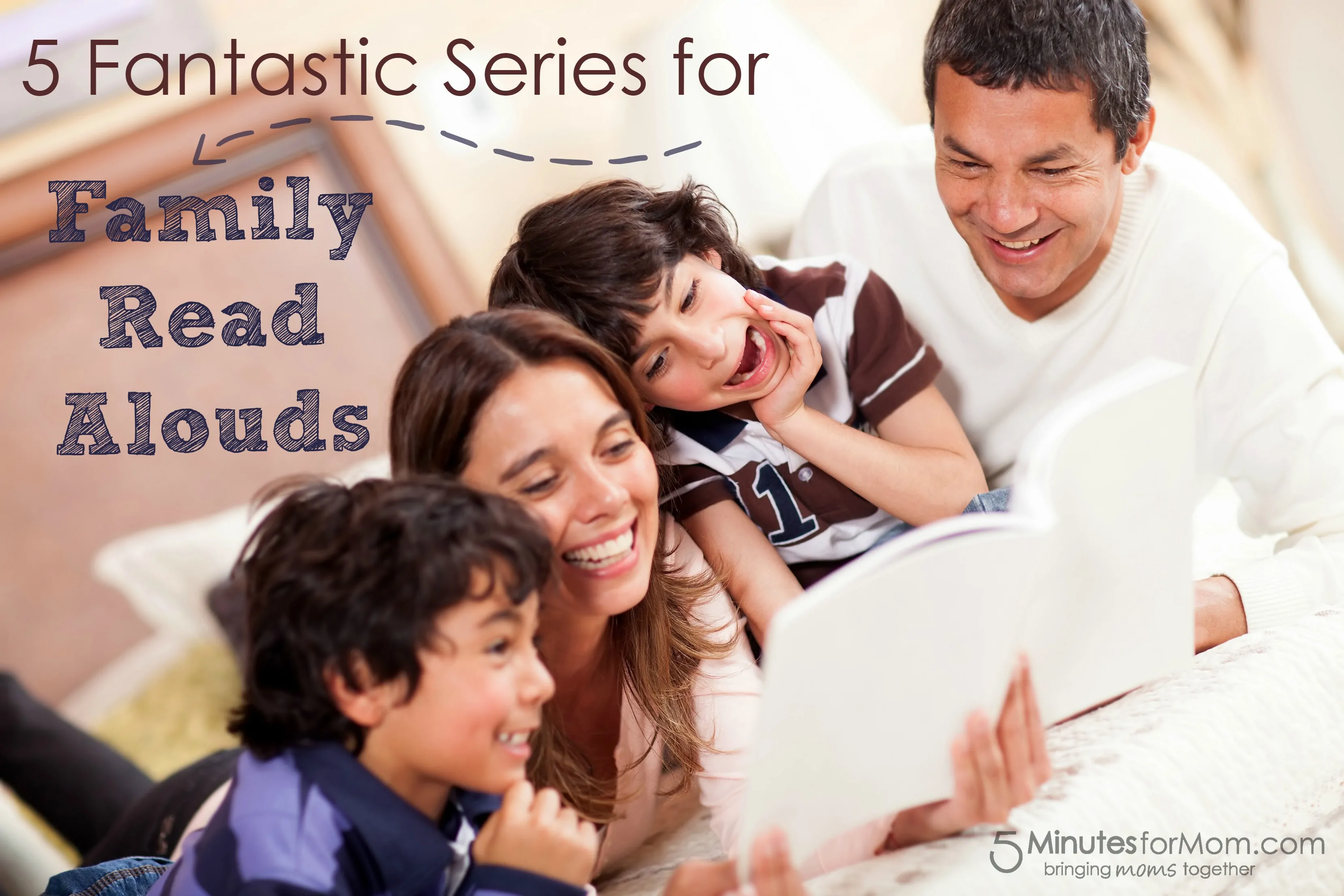 Happy family reading a book in bed