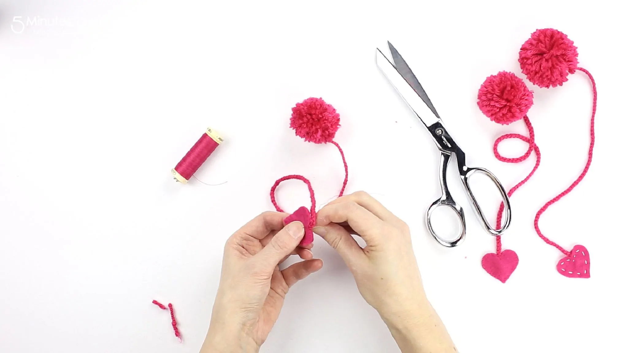 sewing a felt heart to the end of the bookmark