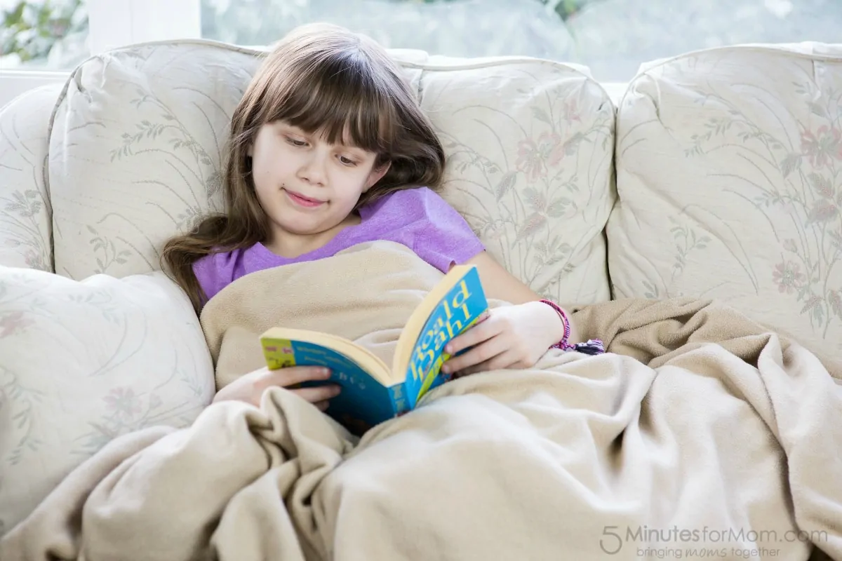 Sophia reading under a blanket