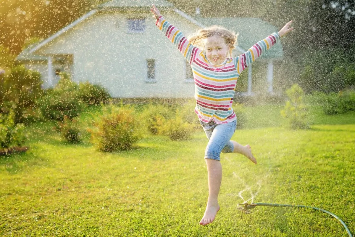 Summer Fun Running Through a Sprinkler