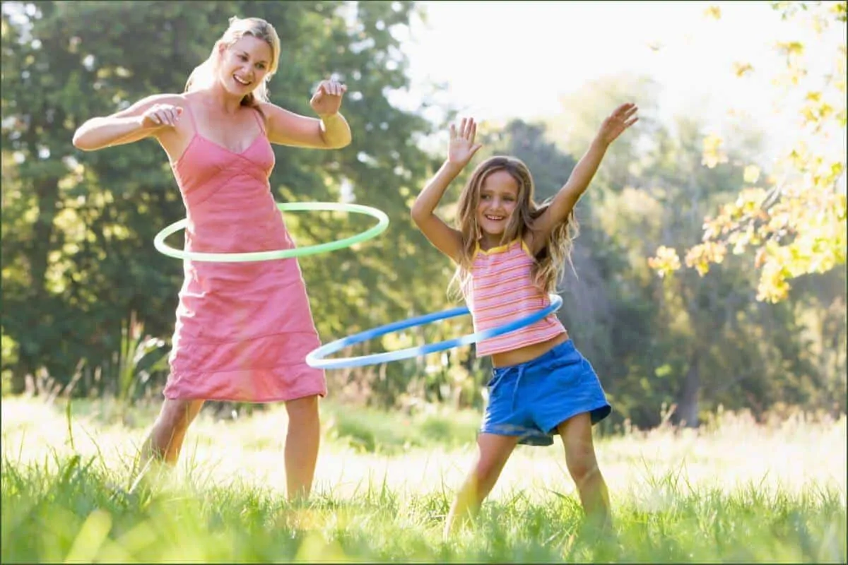 Mother and daughter hula hooping