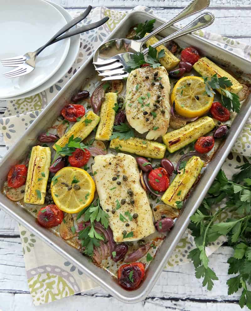 Mediterranean Cod Sheet Pan Dinner. Thinly slicing the garlic and quartering the zucchini ensures that they cook through in the same time as the fish.