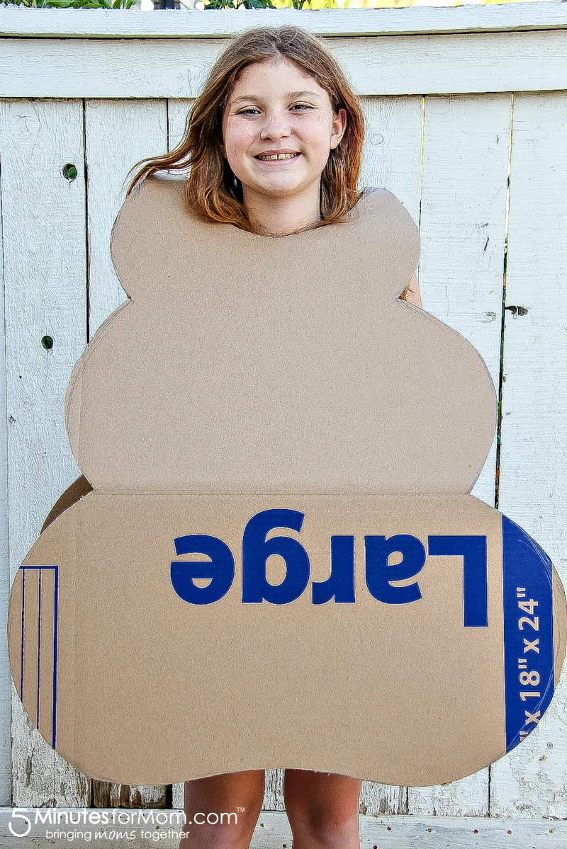 place cardboard cut-out over child's head to make sure it fits