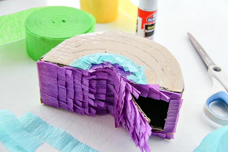 attach the crepe paper streamers to pinata