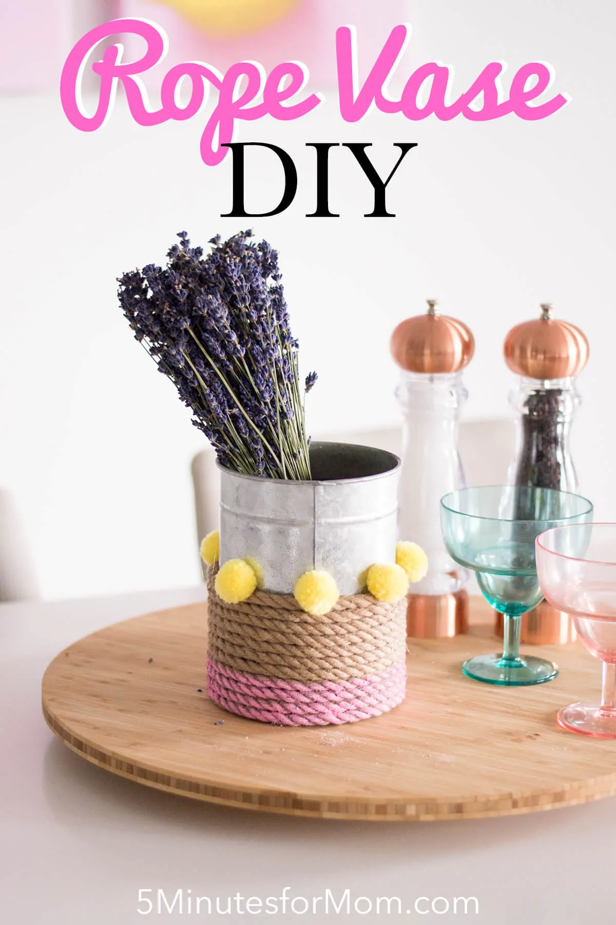 A Rope Vase DIY to add that touch of color to your home. How can you go wrong with pink, pompoms, and a bouquet of flowers?