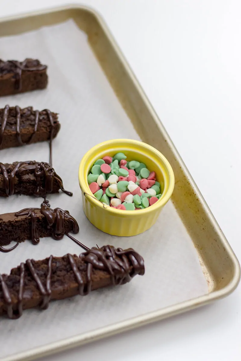 Close up of holiday chocolate chips and baked chocolate biscotti.