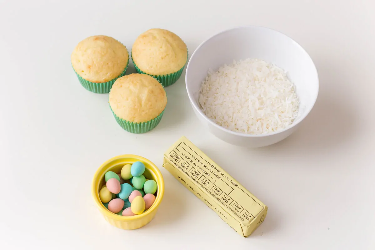 Ingredients for Bird's Nest Cupcakes - Vanilla cupcakes topped with buttercream, shredded coconut and candied eggs.