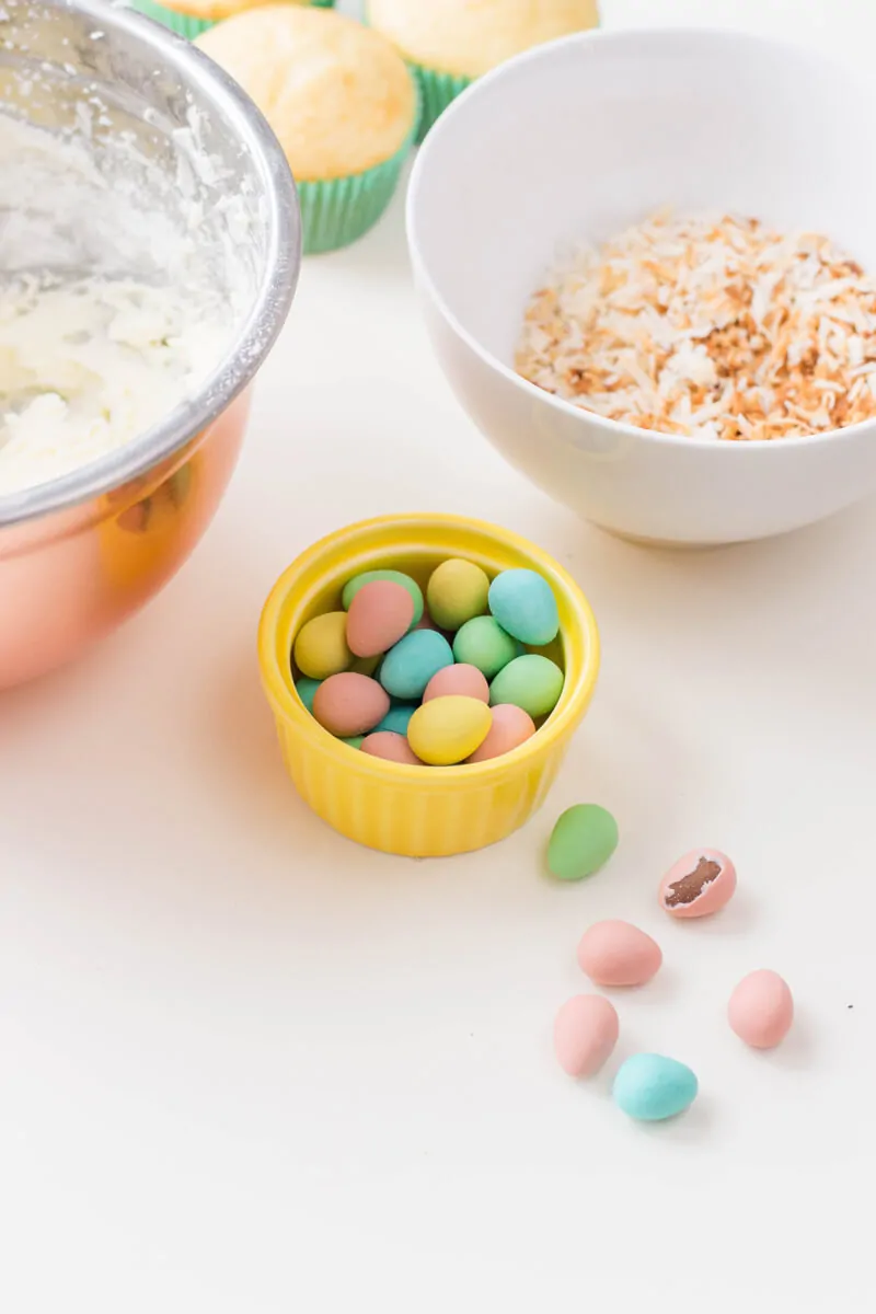 Adding candied eggs to Bird's Nest Cupcakes