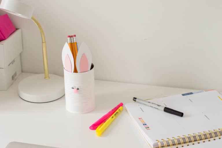 An Easter DIY made of a painted tin can with bunny ears and a pompom nose. Here's our very own Bunny Pencil Holder.