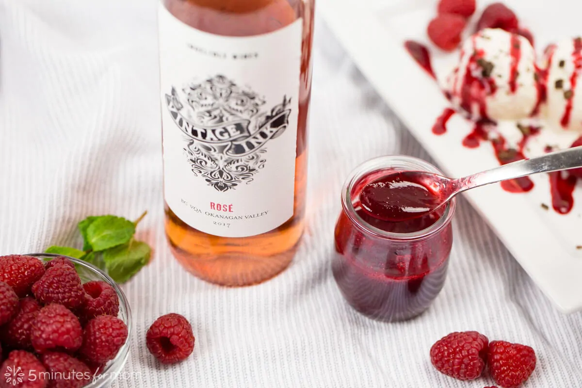 Raspberry Coulis next to a rose wine bottle