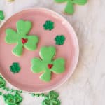 St. Patrick's Day Sugar Cookies shaped as lucky clovers with green fondant and a frosted heart.