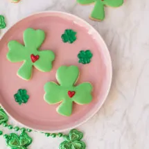 St. Patrick's Day Sugar Cookies shaped as lucky clovers with green fondant and a frosted heart.