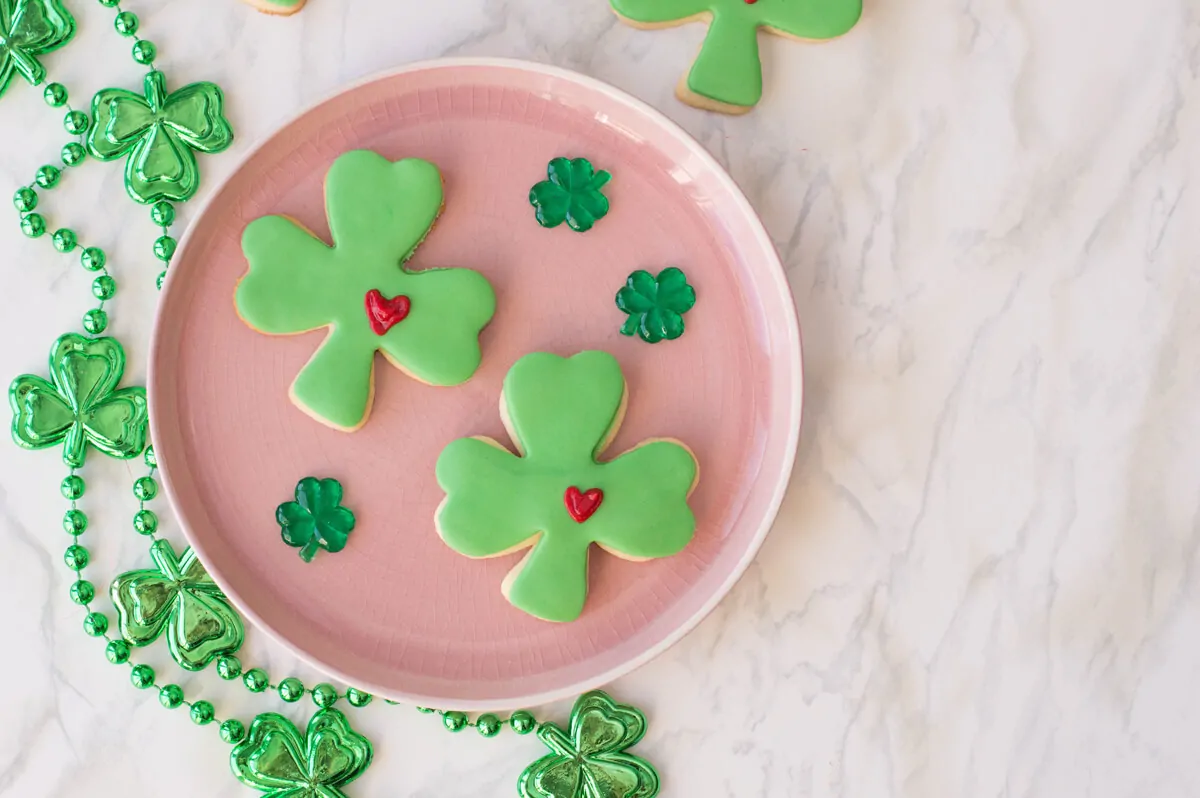 St. Patrick's Day Sugar Cookies shaped as lucky clovers with green fondant and a frosted heart.