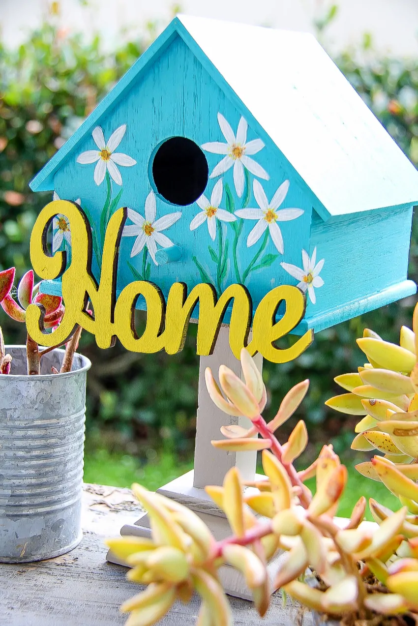 Painted Birdhouses - Decorated birdhouse painted blue with daffodil flowers using acrylic paint and sealer to protect the bird house from the weather.