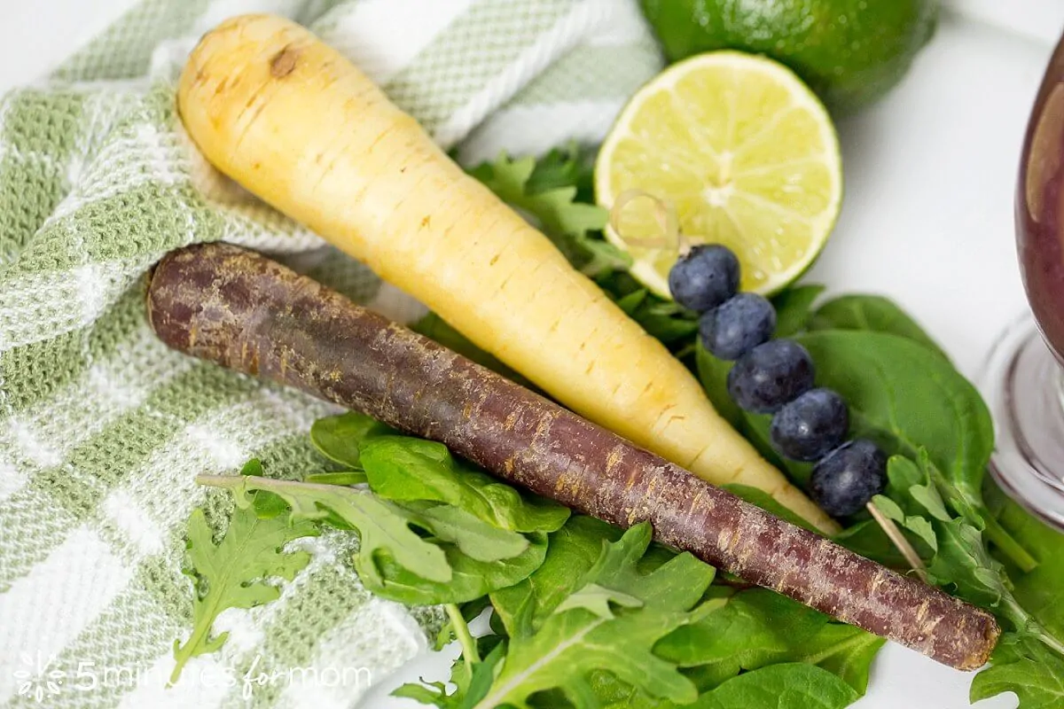 Healthy smoothie ingredients including purple carrots, and power greens