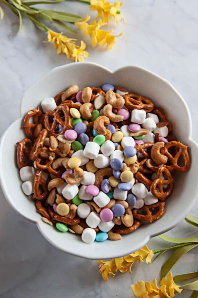 Easy Spring Snack Mix - snack mix in a white bowl on a white marble background