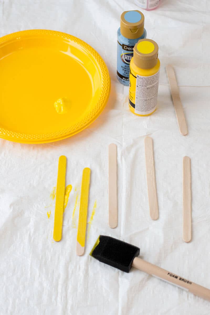 Painting Popsicle Sticks Yellow