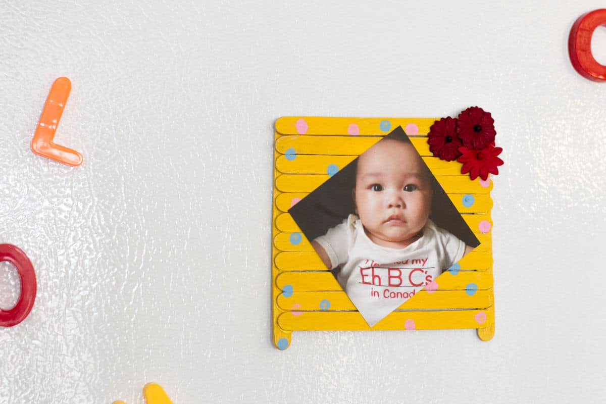 Popsicle Stick Picture Frame - A kid-friendly Mother's Day gift made up of popsicle sticks, paint, and your favorite photo