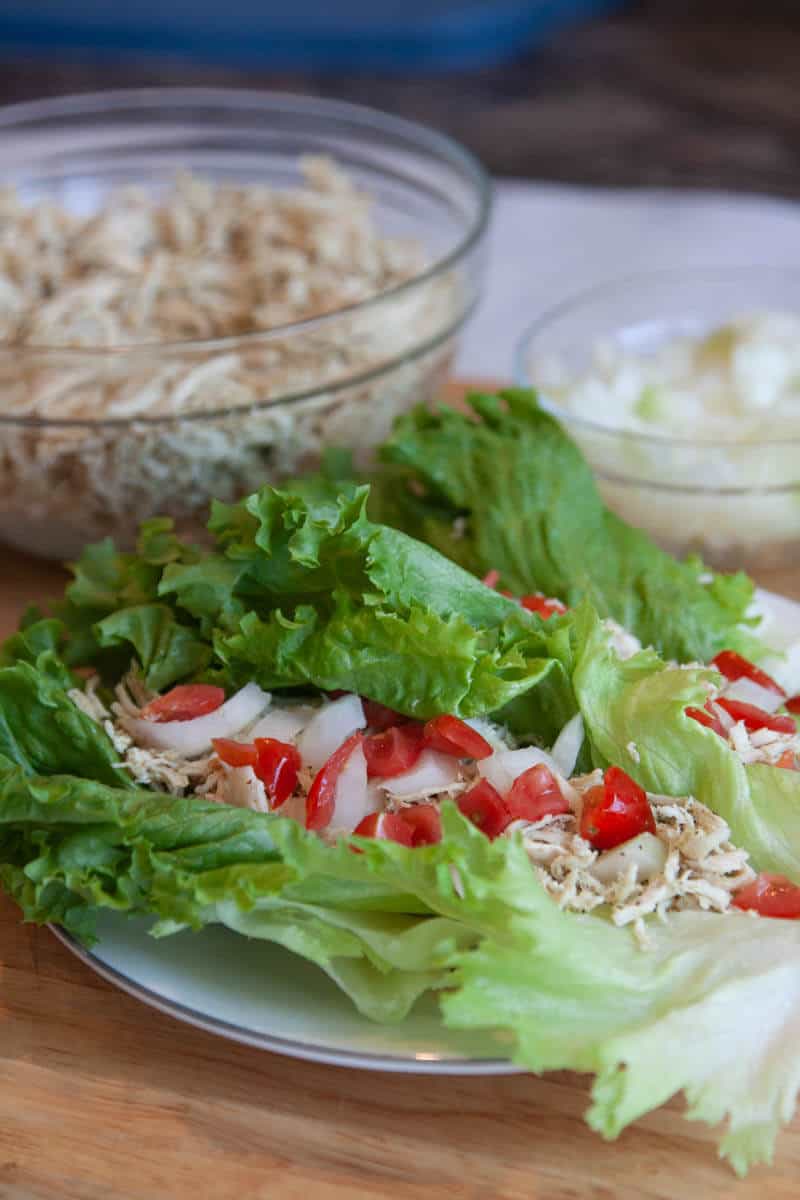 Shredded chicken lettuce wrap with tomatoes and onions