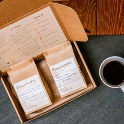 Gift box with two bags of specialty coffee and a cup of coffee - awesome gift idea