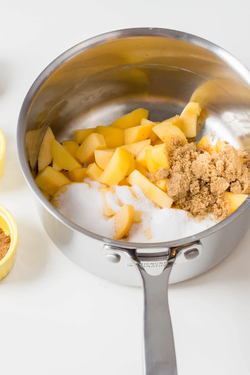 Place peaches and both sugars in a medium-sized saucepan and heat over medium-high.