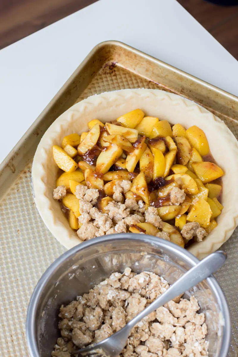 Add crumble on top of the Peach Crumble Pie