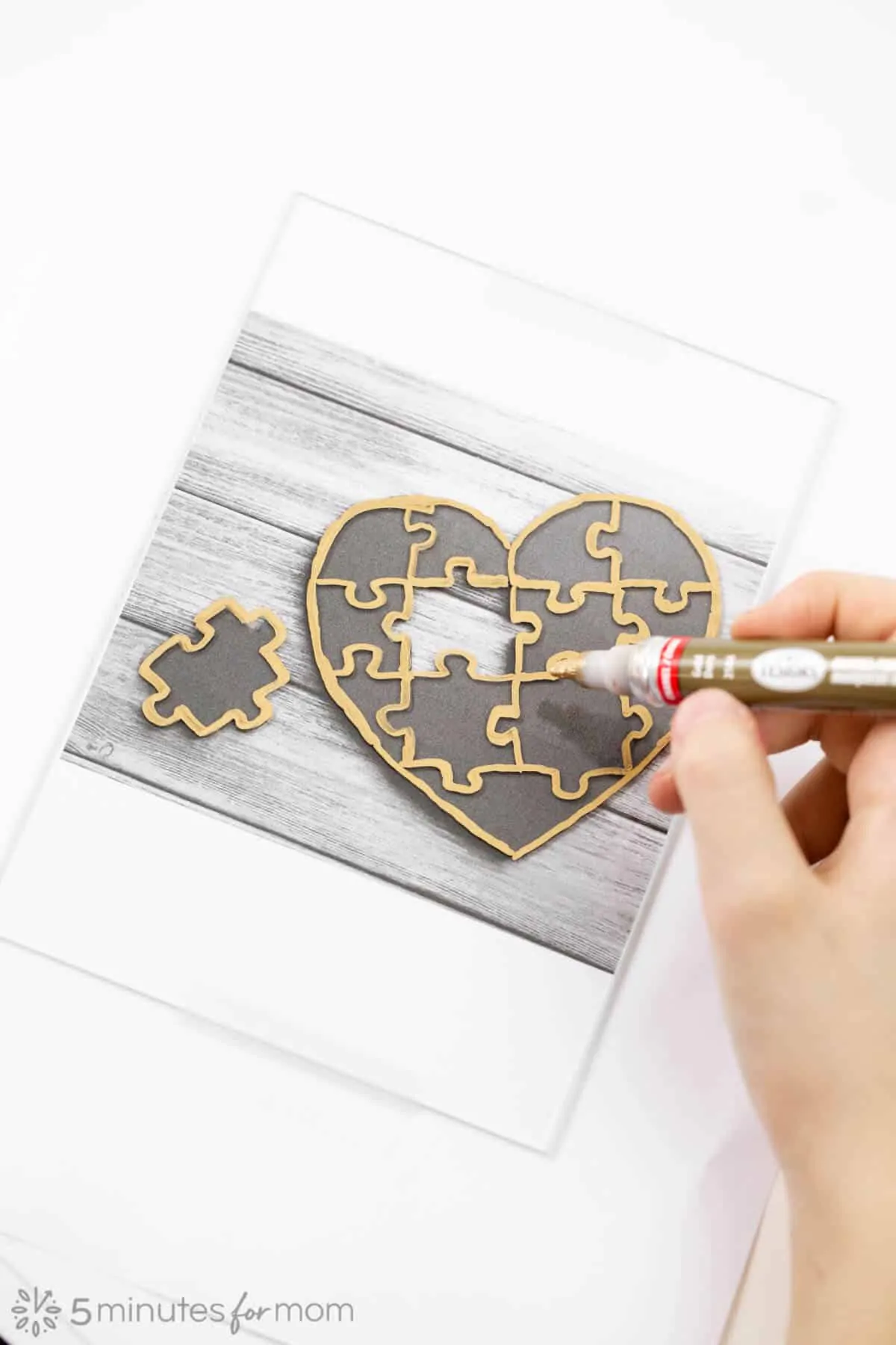 Trace heart shaped puzzle template with enamel paint pen