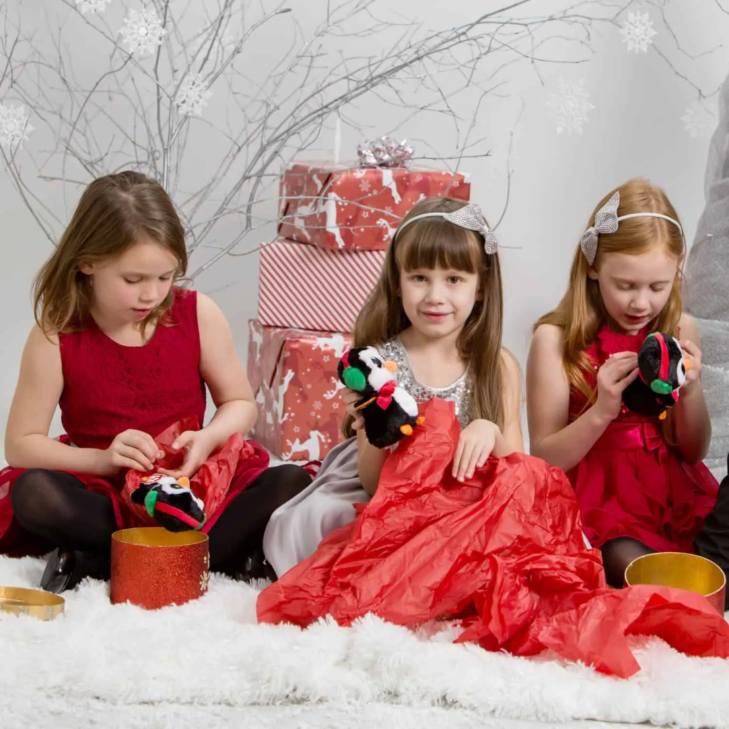 Girls opening Christmas gifts