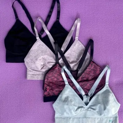 Four different color sports bras for women on a purple background - Smart Christmas gift idea for women