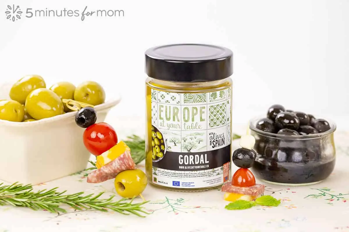 Gordal Olives in a jar and serving dish along with olive skewers