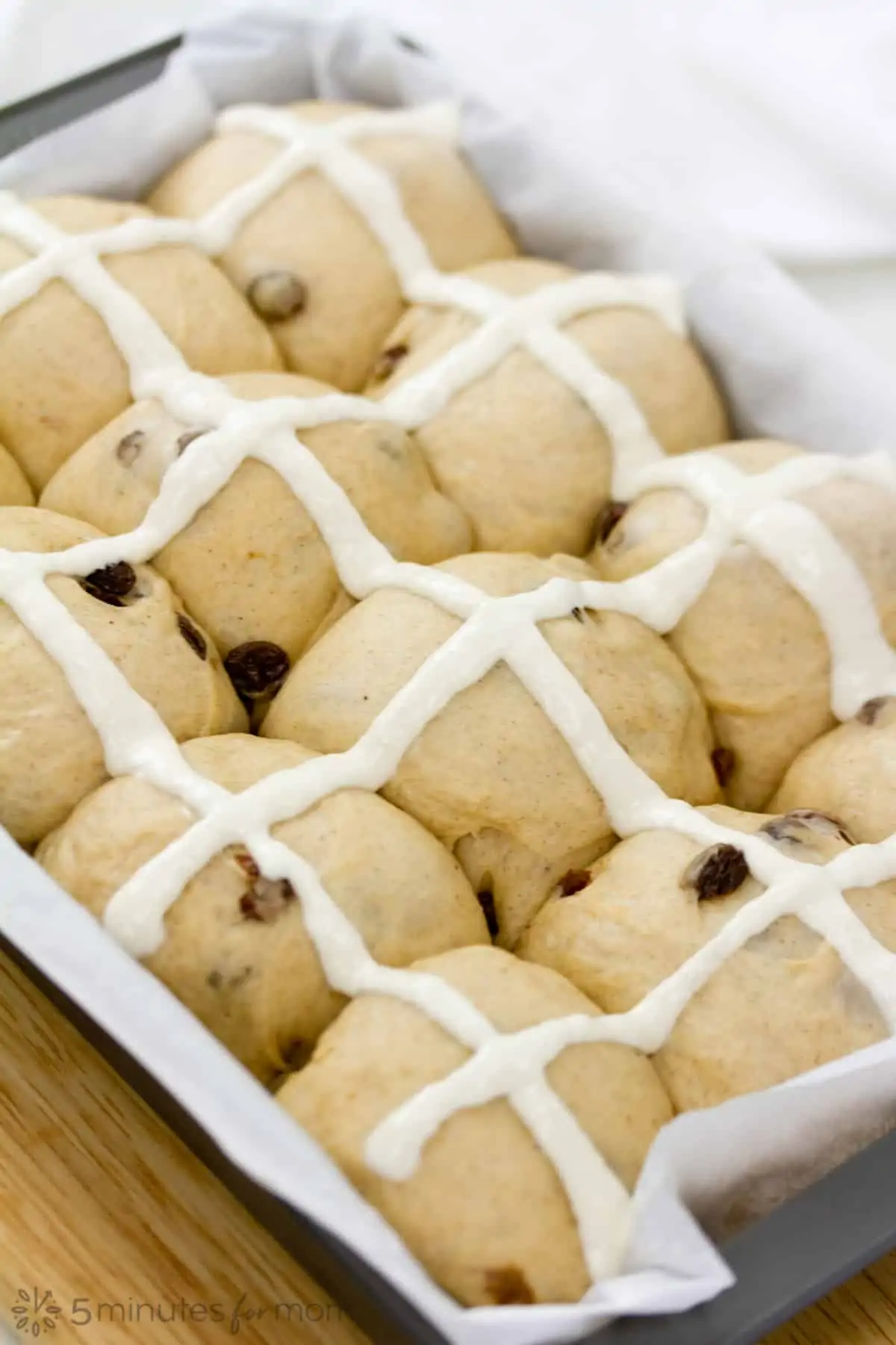 crosses made on hot cross buns with a flour and water paste piped in vertical and horizontal lines to create crosses on each bun