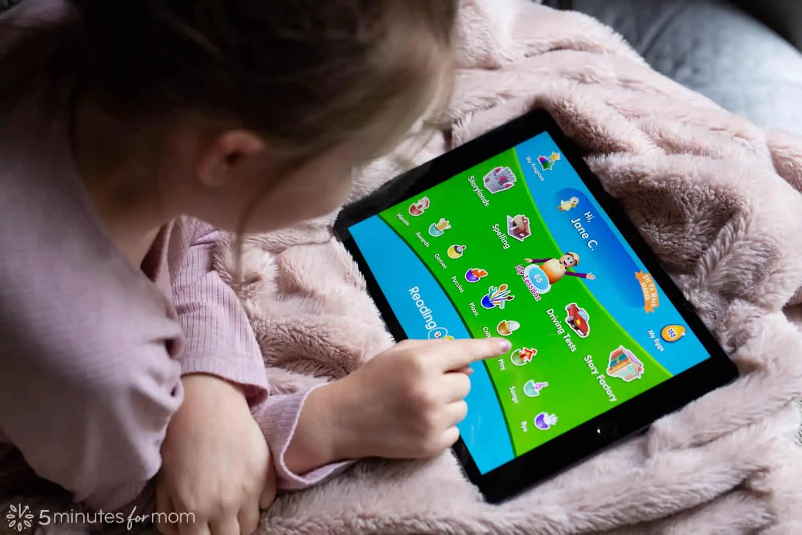 Child using Reading Eggs looking at the home screen on an Ipad