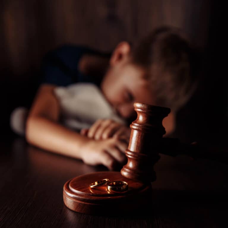 Young boy with teddy bear behind a court gavel - Image representing Divorce in Family Courts