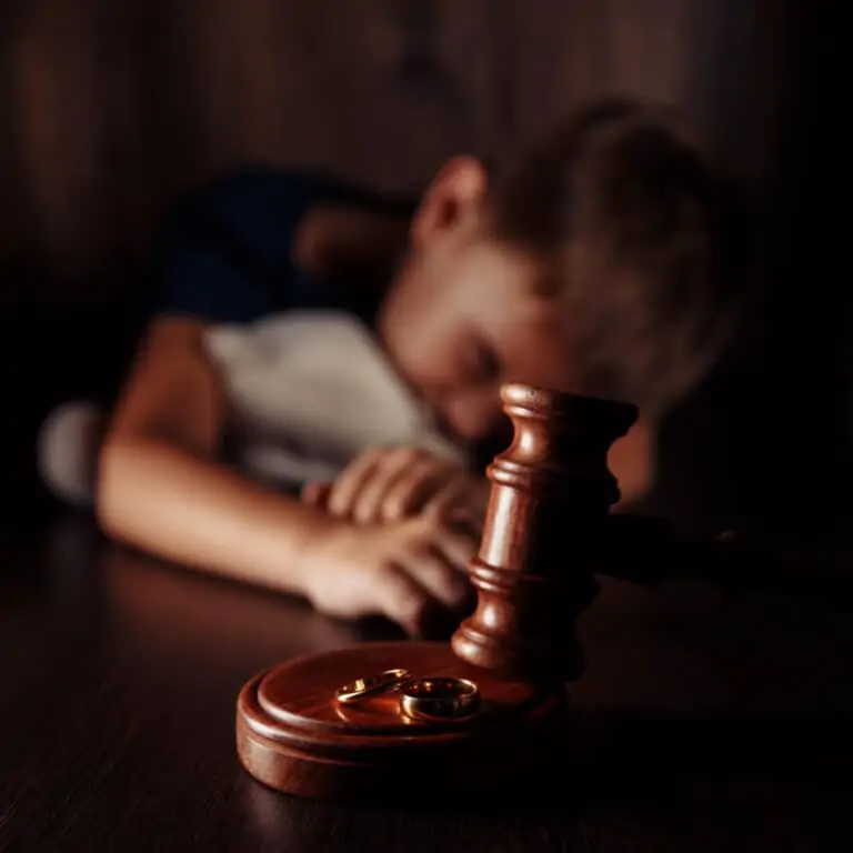 Young boy with teddy bear behind a court gavel - Image representing Divorce in Family Courts
