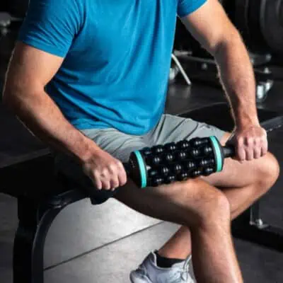 Guy at gym using Chirp Rolling Percussive Massager to show a cool Christmas gift for guys