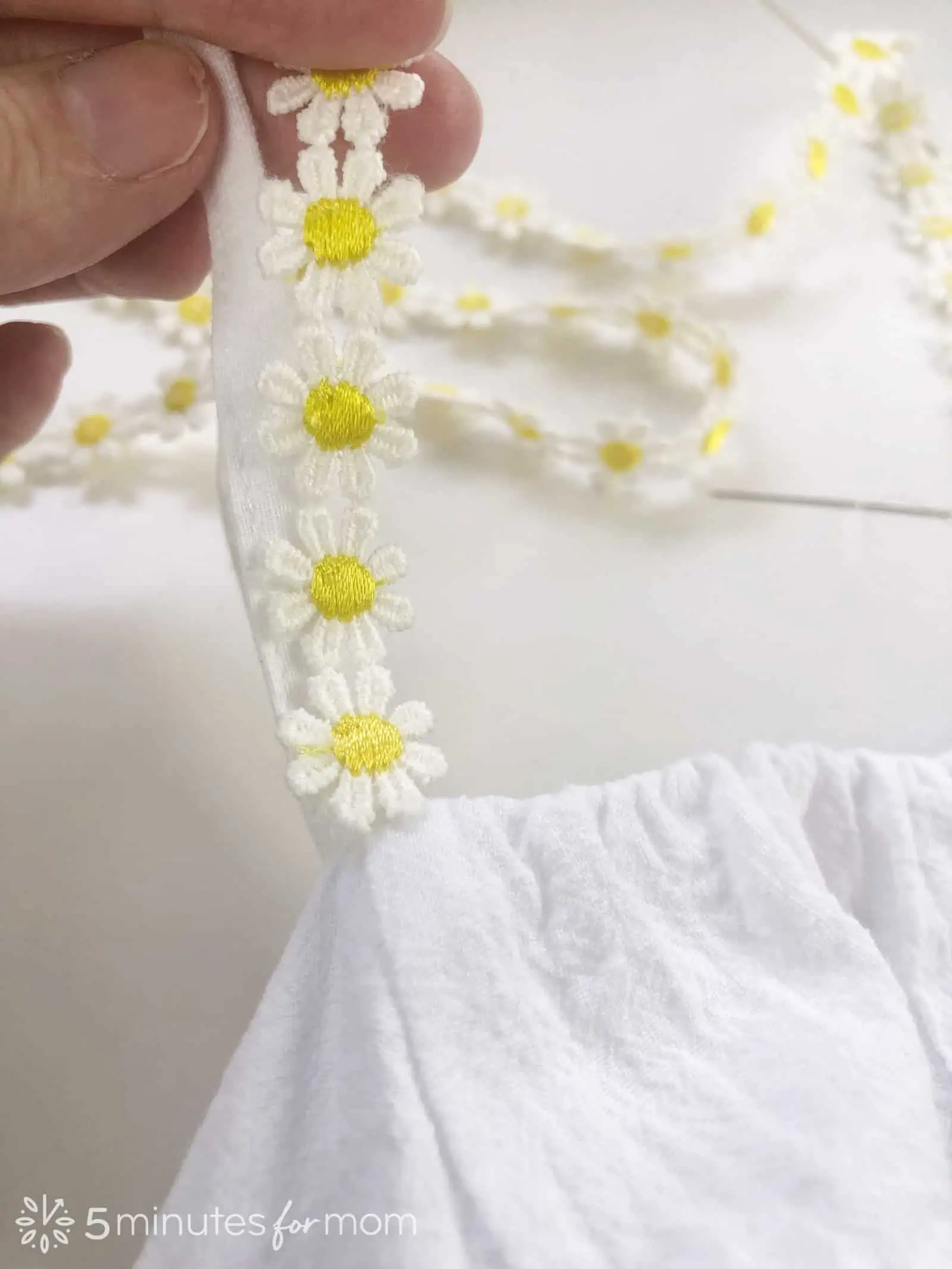 hand sew daisy trim to a white sundress for Easy Eras Tour Outfit