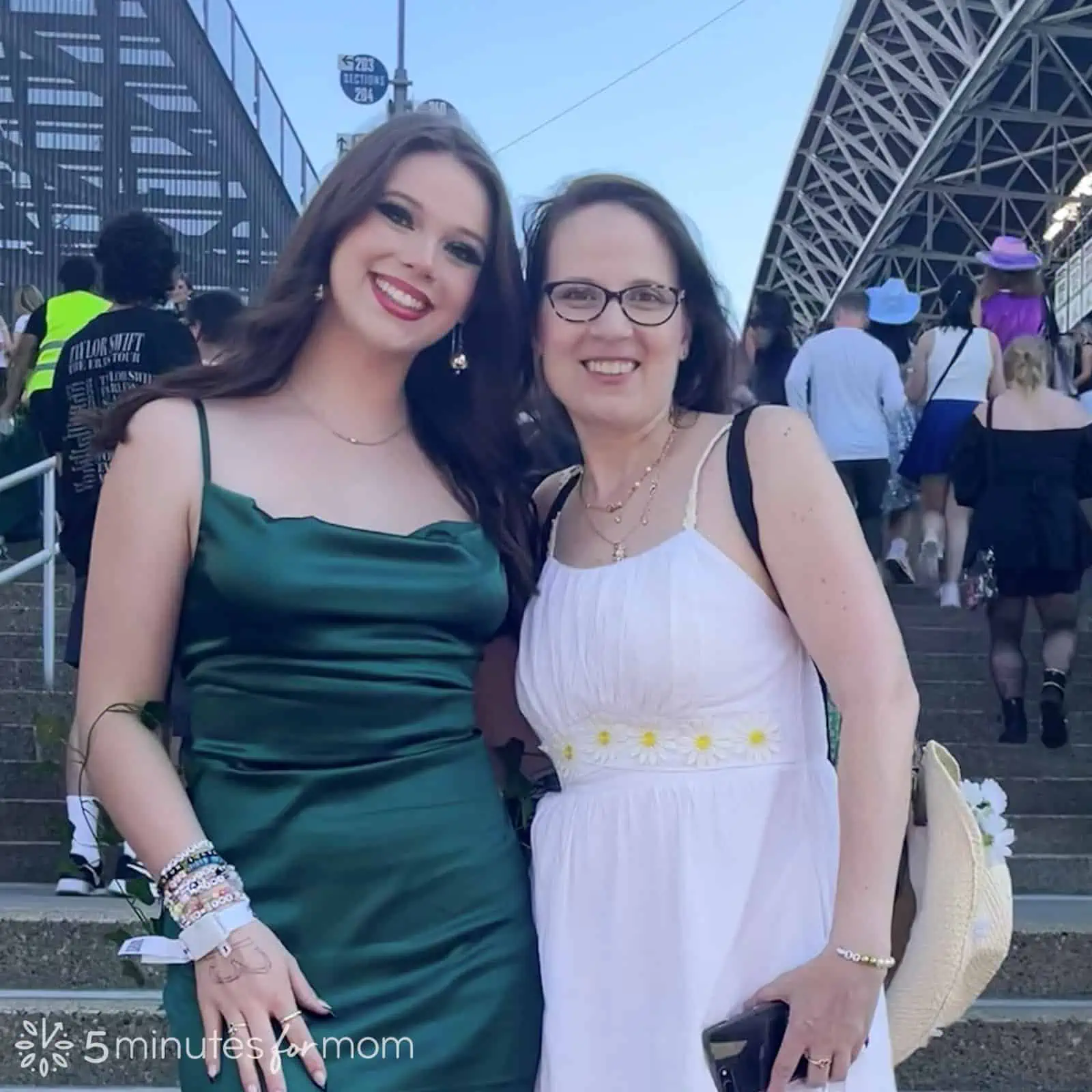 Mom and teenage daughter dressed as Poison Ivy and Daisy on steps at Taylor Swift Eras Tour