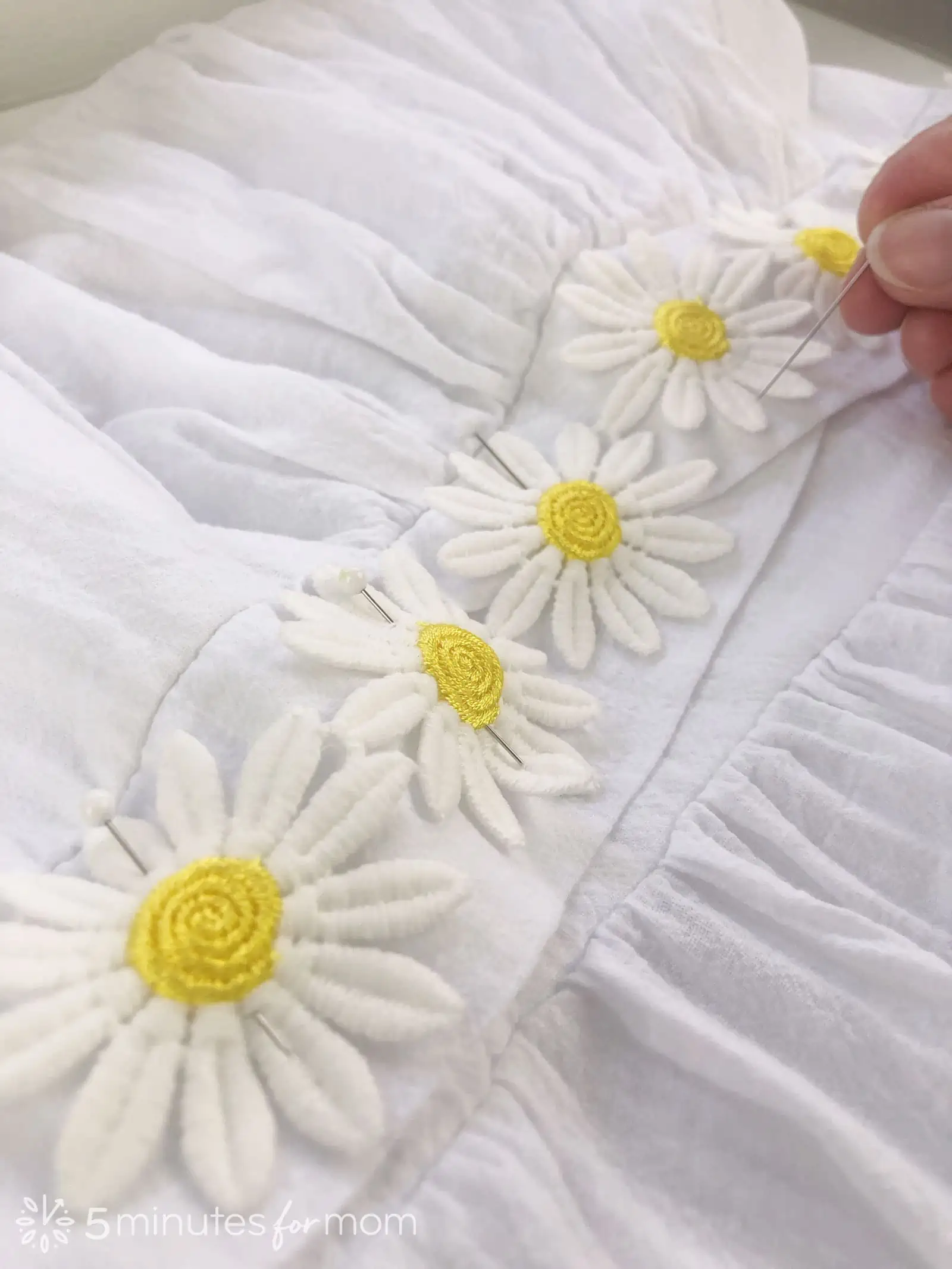 hand sew embroidered daisies to a white sundress for Easy Eras Tour Outfit